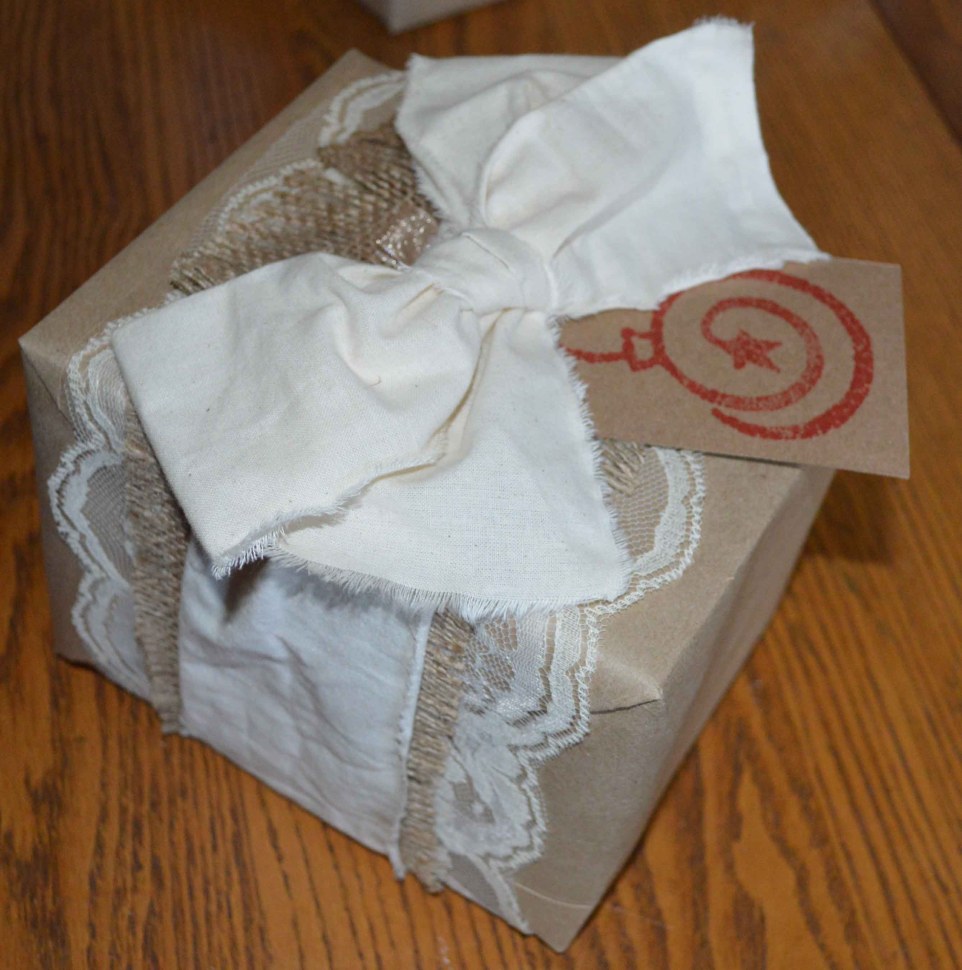 Wrapped in kraft paper, embellished with lace, burlap, muslin and a handmade tag. 